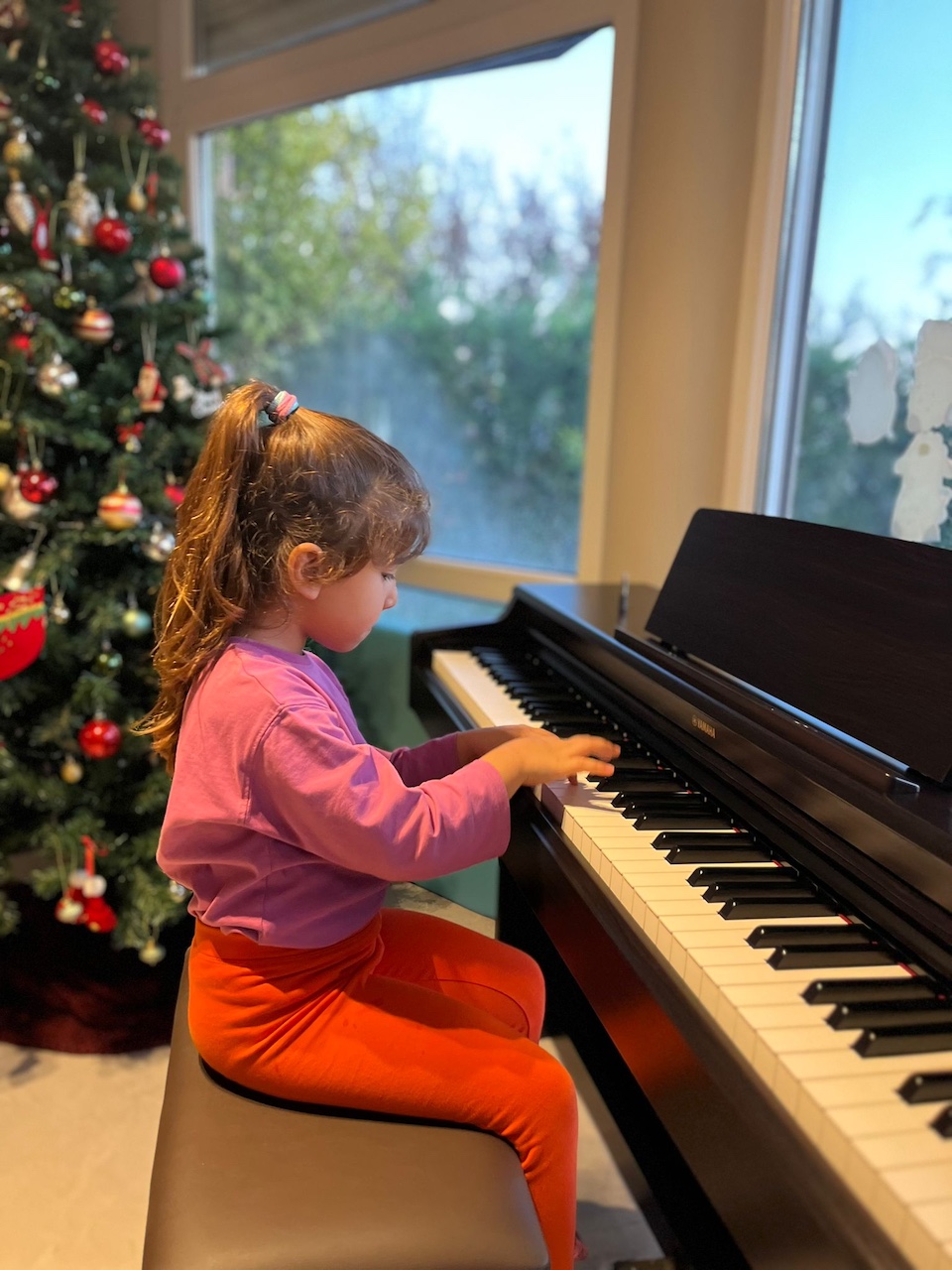 Maya playing her new piano